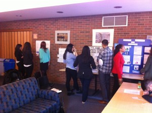 Student research posters being examined by conference attendees