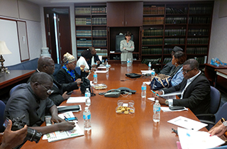 A photo showing participants of the training session around a conference table.